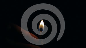 Fire of a wooden match in complete darkness, disappears from the flame on a black background, lighting and burning until