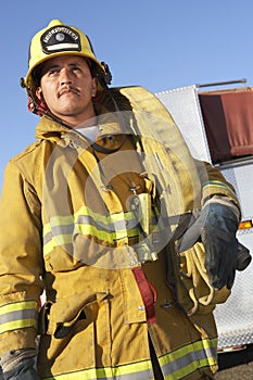 Fire Worker Carrying Firehose On Shoulder