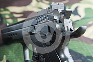 Firearm Pistol on military camouflage background
