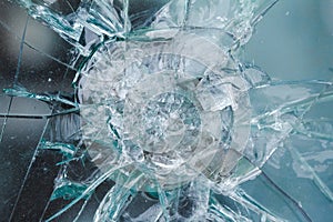 Firearms bullethole on bulletproof glass, cracks background