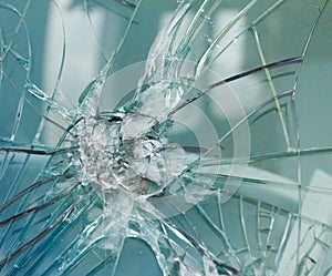 Firearms bullethole on the glass from the bullets, cracks background