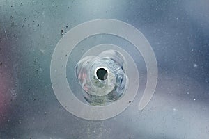 Firearms bullethole on the glass from the bullets, cracks background photo