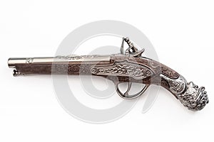Firearms dating to the american revolution and antique collectables concept with ornate old fashioned dueling flintlock pistol