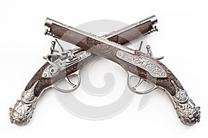 Firearms dating to the american revolution and antique collectables concept with ornate old fashioned dueling flintlock pistols