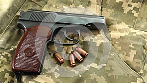 Firearms on military uniform. Top view of a gun with bullets. Military weapons of the USSR.