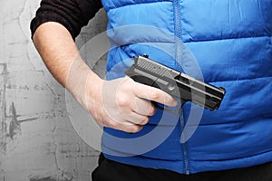 Firearms for self-defense. Black pistol in male hand