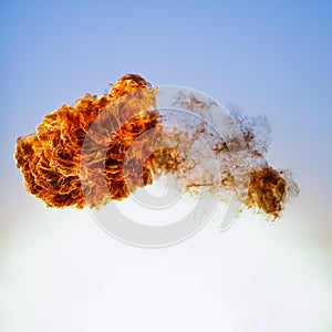 Fireball explosion on blue sky background