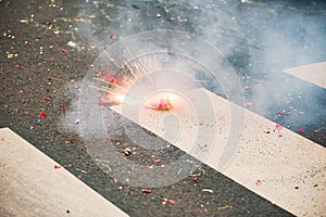 Firecracker exploding on the asphalt of a street