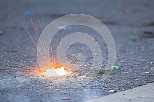 Firecracker exploding with light splash on the road during Phuket vegetarian festival