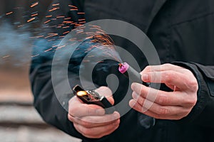 Firecracker Burning in Hand with Sparks and Smoke