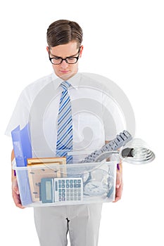 Fired businessman holding box of belongings