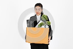 Fired dismissal young Asian business woman in suit holding box with personal belongings on white isolated background. Unemployment