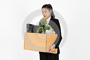 Fired unemployed young Asian business woman in suit holding box with personal belongings on white isolated background.