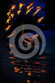 Firedancer woman in water