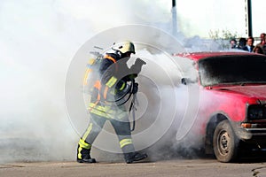 Firefighter and burning car