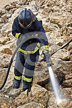 Firefighter cleaning a contaminatea area