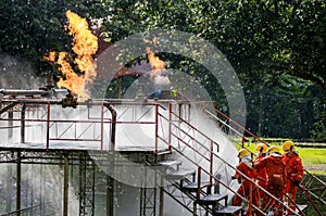 Firefighter Concept. Fireman using water and extinguisher to fighting with fire flame. firefighters fighting a fire with a hose an