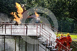 Firefighter Concept. Fireman using water and extinguisher to fighting with fire flame. firefighters fighting a fire with a hose an