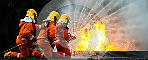 Firefighter Concept. Fireman using water and extinguisher to fighting with fire flame. firefighters fighting a fire with a hose an