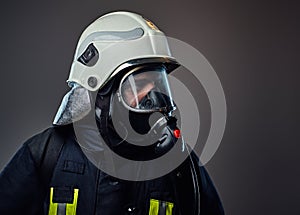 Firefighter dressed in uniform and an oxygen mask.