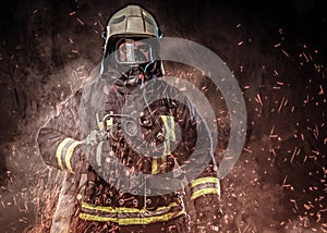 A firefighter dressed in a uniform in a studio.