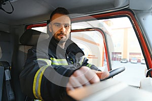 Firefighter drives a emergency vehicle with communication interior view