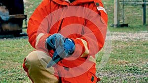 Firefighter fighting with flame using fire hose chemical water foam spray engine. Fireman wear hard hat, body safe suit uniform