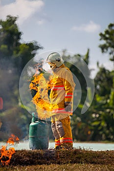 Firefighter with fire and suit for protect fire fighter for training firefighters