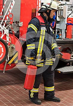 Firefighter on the fire truck used a fire extinguisher