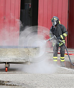 firefighter with foaming dispenser turns off fire during rescue