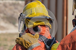 Firefighter hand put on shoulder of first man for signal in fire