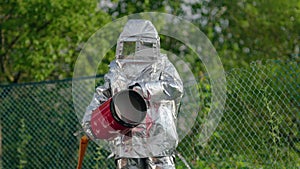 A firefighter in a heat-reflective and heat-protective suite