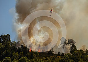 Firefighter Helicopter fighting against a Forest Fire during Day in Povoa de Lanhoso.