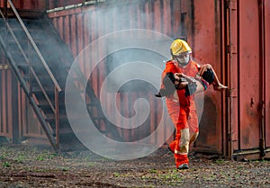 Firefighter help little girl out from room with fire and smoke and he bring child pass through window of the room and run out from