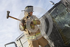 Firefighter Hitting Crashed Car With Axe