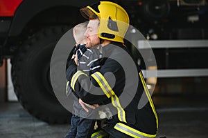 Firefighter holding child boy to save him in fire and smoke,Firemen rescue the boys from fire