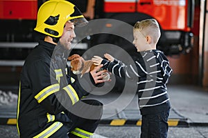 Firefighter holding child boy to save him in fire and smoke,Firemen rescue the boys from fire