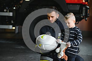 Firefighter holding child boy to save him in fire and smoke,Firemen rescue the boys from fire