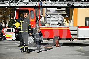 Firefighter holding child boy to save him in fire and smoke,Firemen rescue the boys from fire