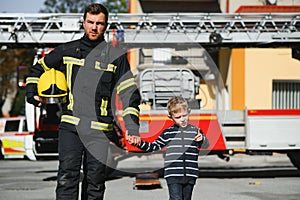 Firefighter holding child boy to save him in fire and smoke,Firemen rescue the boys from fire