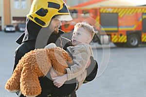 Firefighter holding child boy to save him in fire and smoke,Firemen rescue the boys from fire