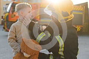 Firefighter holding child boy to save him in fire and smoke,Firemen rescue the boys from fire