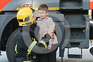 Firefighter holding child boy to save him in fire and smoke,Firemen rescue the boys from fire