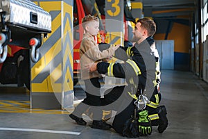 Firefighter holding child boy to save him in fire and smoke,Firemen rescue the boys from fire