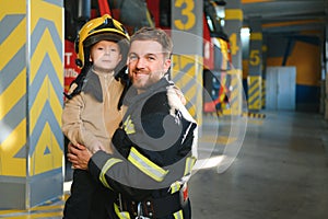 Firefighter holding child boy to save him in fire and smoke,Firemen rescue the boys from fire