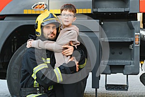 Firefighter holding child boy to save him in fire and smoke,Firemen rescue the boys from fire