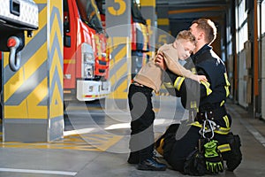 Firefighter holding child boy to save him in fire and smoke,Firemen rescue the boys from fire