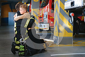 Firefighter holding child boy to save him in fire and smoke,Firemen rescue the boys from fire