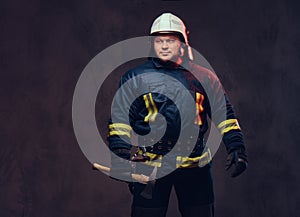 Firefighter holds the axe.