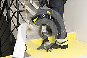 A firefighter holds a helmet in his hands, a close-up view from below